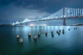 城市跨江大桥夜景下的桥墩木桩