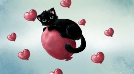 趴在红色卡通心脏上的黑猫